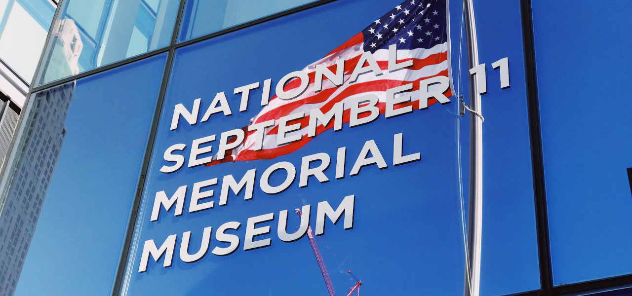 American flag with sign saying National September 11 Memorial Museum