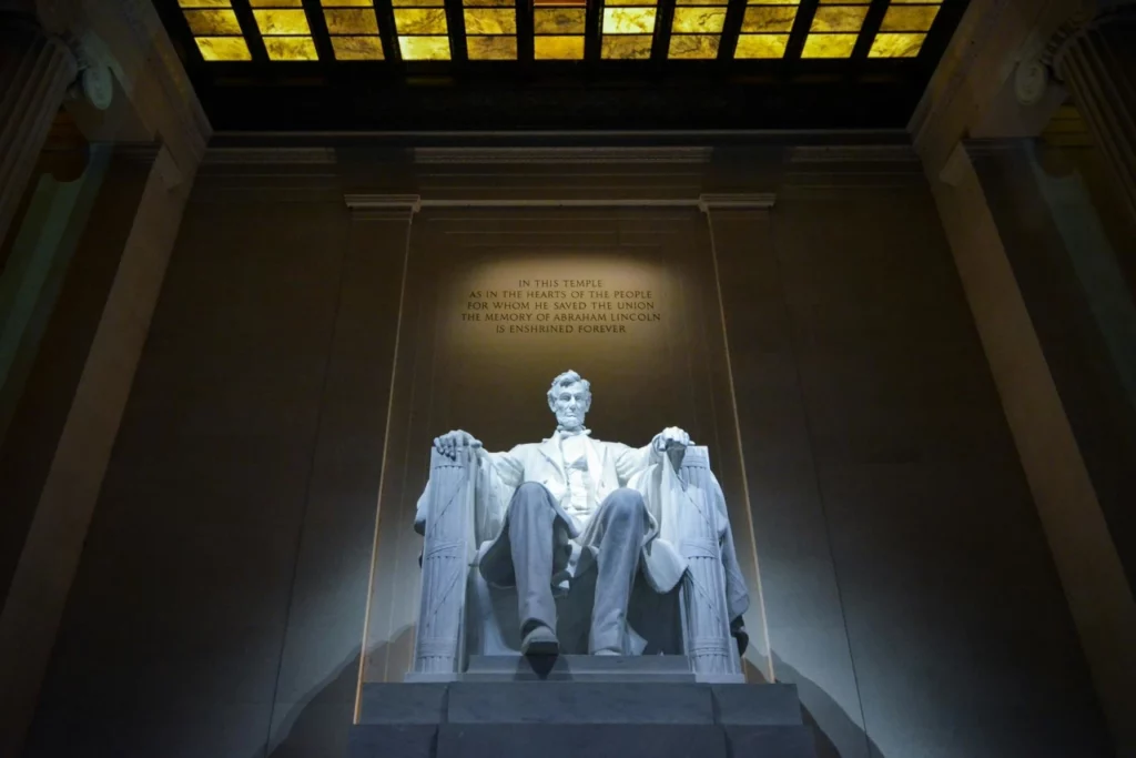 The statue of Abraham Lincoln sitting in Washington DC's Lincoln Memorial.